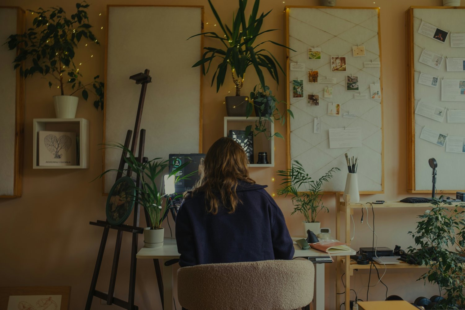 Woman in a home office with her back to us